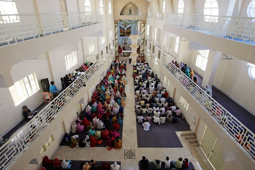 Members of the Pakistani Christian community attend a Sunday service at their new St. Peter's church in Karachi. The domed, three-story building towers over the sprawling slum it serves and is the largest yet in the violent, Muslim country. (Associated Press)