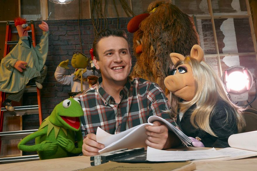 In this film publicity image released by Disney, Jason Segel is shown with muppet characters Kermit the Frog, left, and Miss Piggy, in a scene from "The Muppets." (AP Photo/Disney Enterprises, Andrew Macpherson)