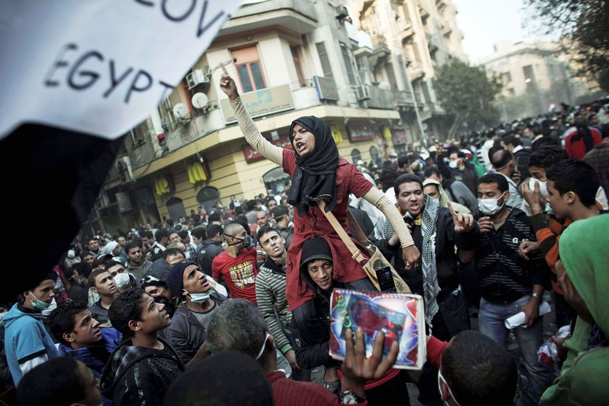 Protesters demonstrate during clashes with Egyptian riot police near Cairo's iconic Tahrir Square on Tuesday. Concessions by the ruling military on turning over power to a civilian government were immediately rejected by protesters, who threatening a "second revolution." (Associated Press)