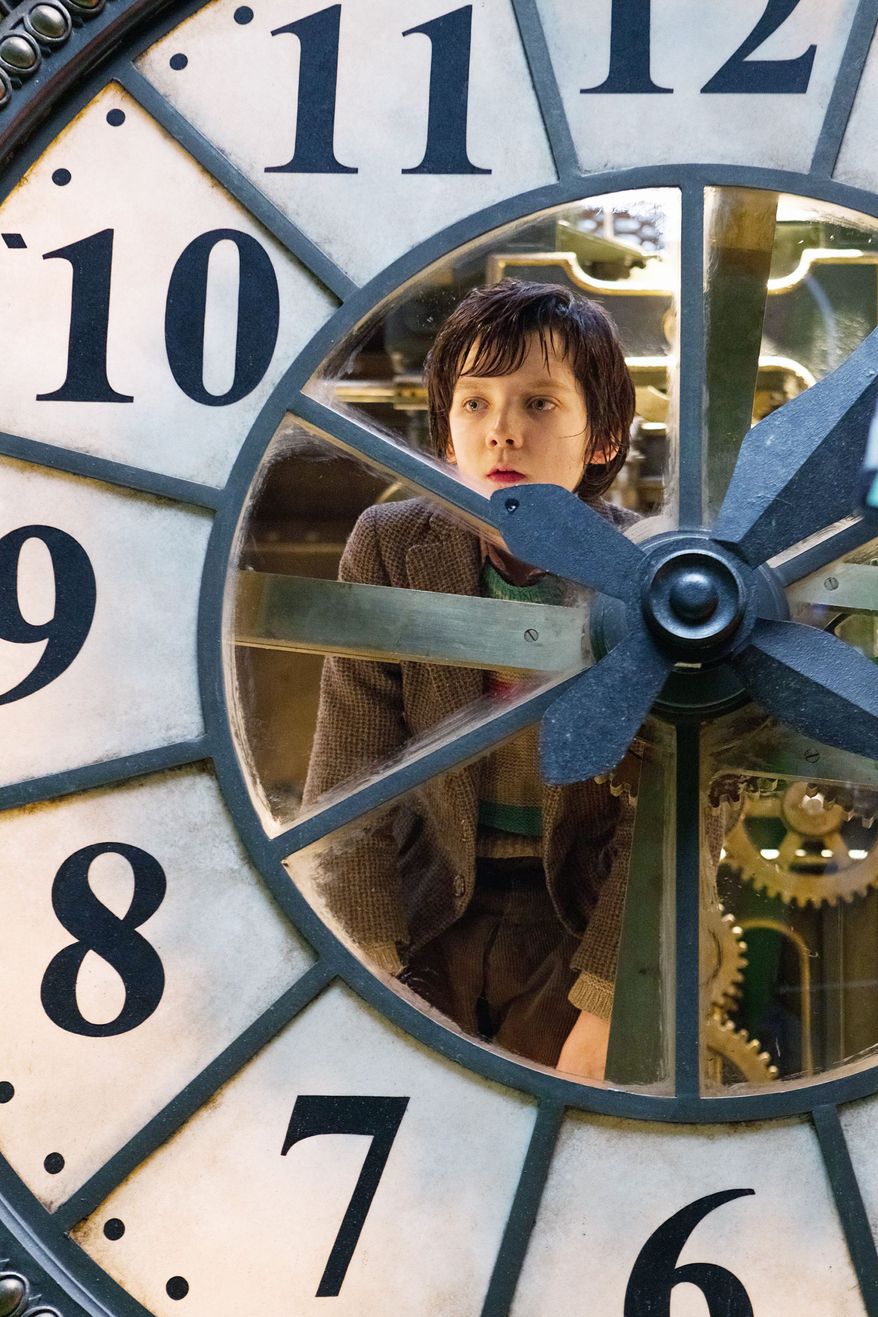 Asa Butterfield portrays Hugo Cabret in "Hugo." The movie, Martin Scorsese's first directing effort in 3-D, tells the story of an orphaned boy who maintains clocks in a train terminal. (Paramount Pictures via Associated Press)