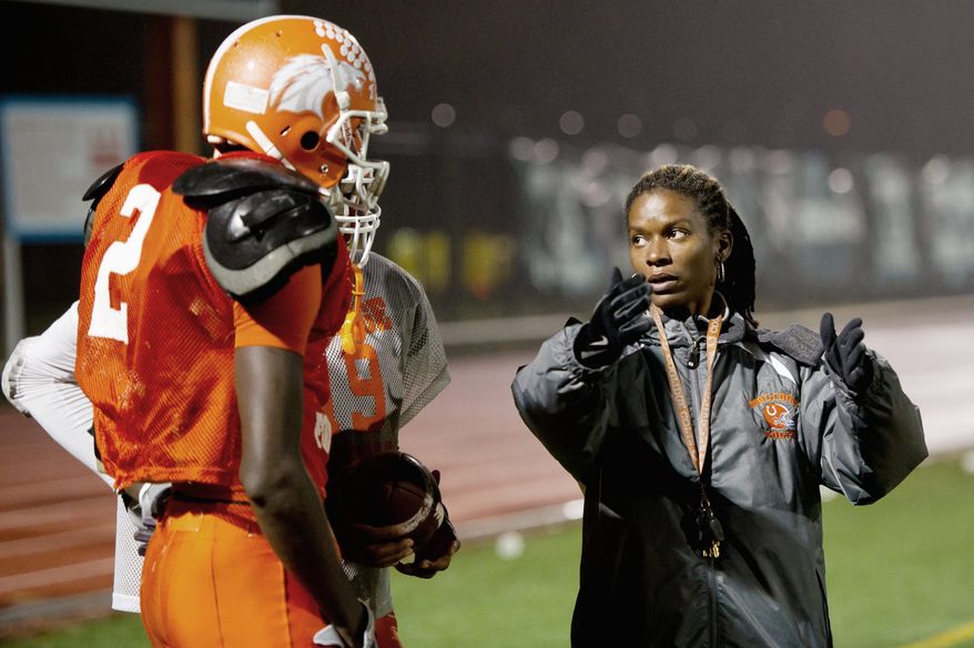 Coolidge receiver Dayon Pratt listens to instructions from head coach Natalie Randolph. (Andrew Harnik/The Washington Times)
