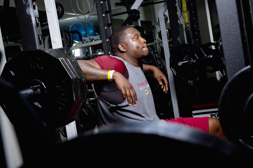 Washington Redskins rookie defensive end Jarvis Jenkins lifts weights at Redskins Park in Ashburn, Va., as part of his rehabilitation from a torn ACL. Jenkins promises his injured right knee will be stronger than ever by the time the 2012 season rolls around. (Andrew Harnik/The Washington Times)