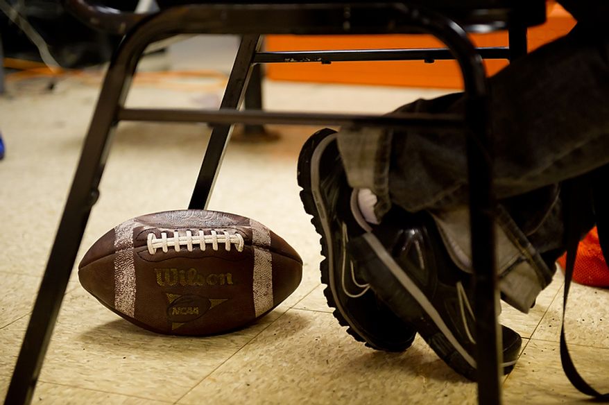 Coolidge High School Football Coach Natalie Randolph sits in the coaches locker room before going out to practice with her team to get ready for the Turkey Bowl, Washington, DC, Monday, November 21, 2011. (Andrew Harnik/The Washington Times)