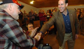 Republican presidential hopeful Rick Santorum greets Gary Gahan, 66, of Merrimack, N.H., at a recent campaign stop in Rochester, N.H. The former senator from Pennsylvania hopes to do well in the Granite State&#39;s Jan. 10 first-in-the-nation primary. (Associated Press)
