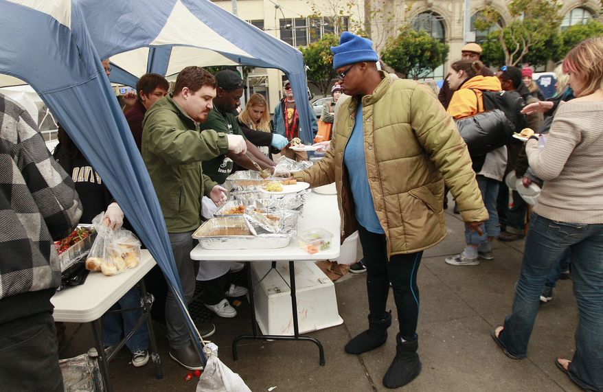 Occupy San Francisco protesters are served a turkey dinner provided by Glide Memorial Church at Justin Herman Plaza in San Francisco on Nov. 24, 2011. (Associated Press)