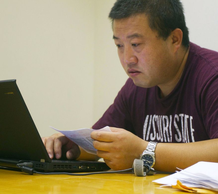 **FILE** Wang Chengdong, a Chinese student in the Executive MBA program, works June 28, 2011, in a library study room at Missouri State University in Springfield, Mo. (Associated Press/The News-Leader)