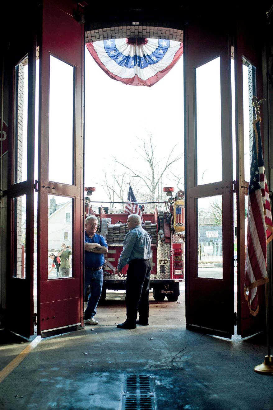Charles Hottinger (center), vice president of IAFF Local 36, talks with Rick Moore, who served as a lieutenant with the D.C. Fire Department's Engine Co. 24, during Sunday's party marking 100 years of service to the Petworth neighborhood. "This milestone represents many things; the most important is the service to the community," Chief Kenneth B. Ellerbe said. (T.J. Kirkpatrick/The Washington Times)