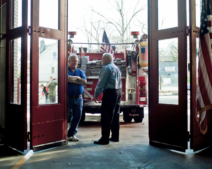 Charles Hottinger, at center, vice president of IAFF Local 36, talks with Rick Moore, who served as a lieutenant in Engine Co. 24 during his career with the D.C. Fire Department, during Engine Company 24's centennial celebration in Washington, D.C. on Nov. 27, 2011.
(T.J. Kirkpatrick/ The Washington Times)