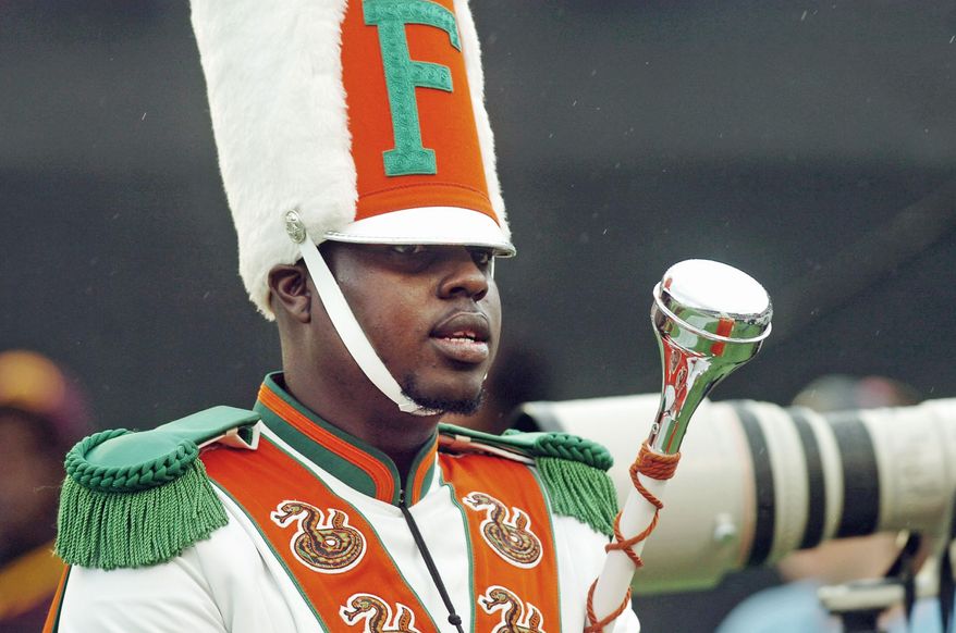 Robert Champion, a drum major in Florida A&M University's Marching 100 band, performs during halftime of a football game in Orlando, Fla., on Saturday, Nov. 19, 2011. (Tampa Tribune via Associated Press)