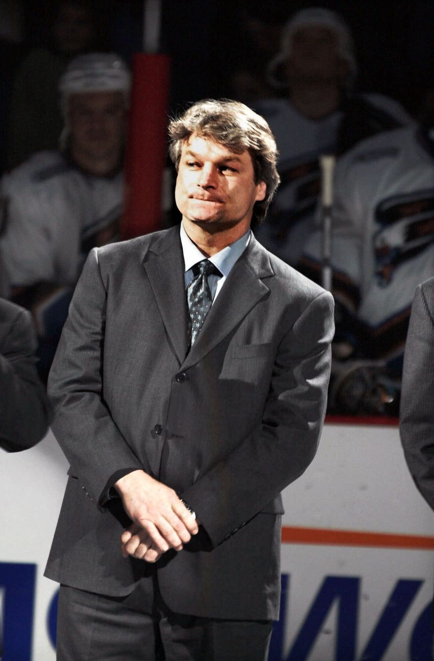 ** FILE ** Former Washington Capitals hockey player Dale Hunter listens as his jersey number is retired during at ceremony at the MCI Center in Washington in March 2000. (AP Photo/Linda Spillers, File)