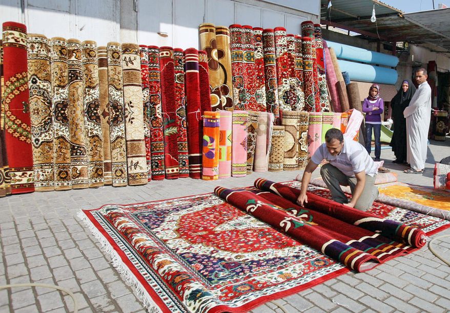 Iranian goods are displayed at a shop in Baghdad. Iran's presence is already visible in Iraq, from the pilgrims at Shiite holy sites to the brands of yogurt and jams on grocery shelves. (Associated Press)