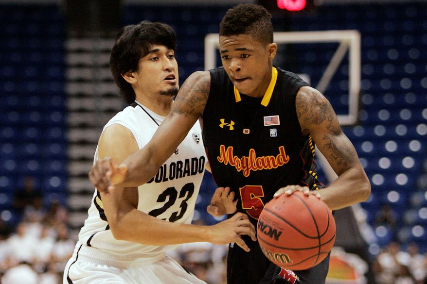 Maryland freshman Nick Faust (right), shown during the San Juan tournament, has 17 turnovers and 15 assists from the point guard position. He's one of two Terrapins to start every game. (Associated Press)
