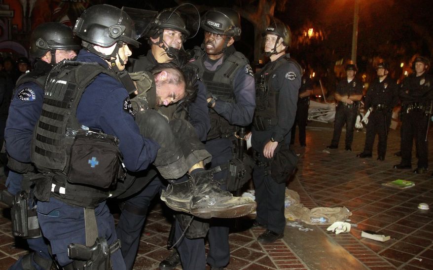 Police arrest an Occupy L.A. protester as they cleared out the Occupy L.A. camp at Los Angeles City Hall on Wednesday, Nov. 30, 2011. (AP Photo/Mark Boster, Pool)