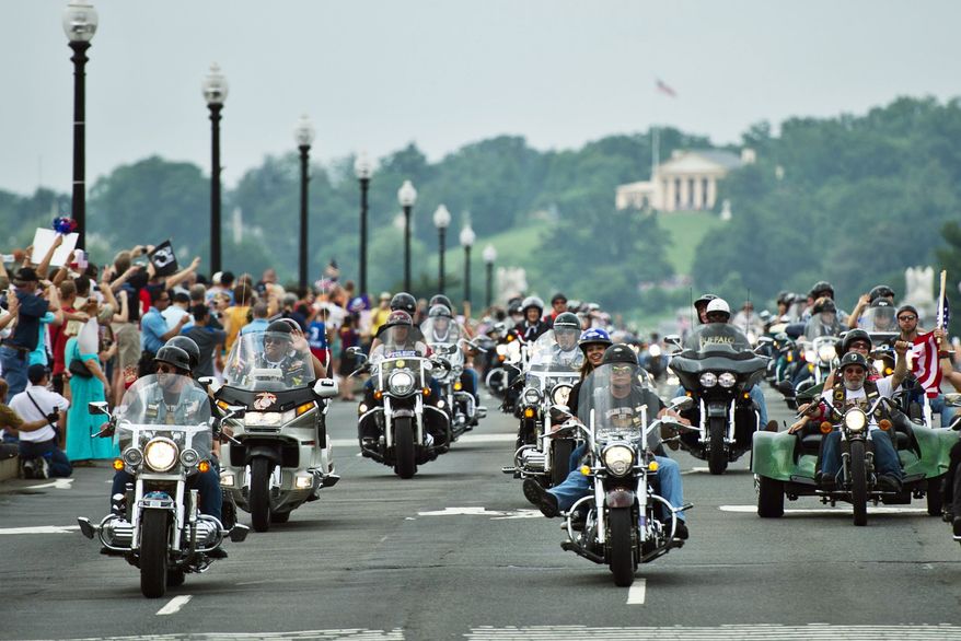** FILE ** Bikers in the Rolling Thunder motorcycle rally ride across Memorial Bridge in Washington, D.C. In Michigan, the repeal of the helmet law is gaining traction. (Drew Angerer/The Washington Times)