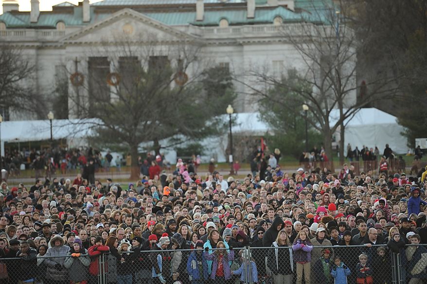 People crowd up along a fence for a glimpse of the celebrations, during The National Christmas Tree Lighting 2011 on The Elipse in Washington, DC, Thursday, December 1, 2011. (Rod Lamkey Jr/ The Washington Times)