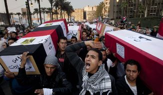 Protesters carry symbolic coffins honoring those killed in recent clashes with security forces during a rally in Tahrir Square, in Cairo, Egypt, Friday, Dec. 2, 2011. Islamists appear to have taken a strong majority of seats in the first round of Egypt&#39;s first parliamentary vote since Hosni Mubarak&#39;s ouster. (AP Photo/Bernat Armangue)