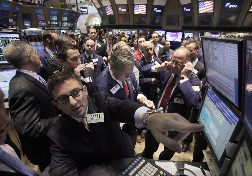 ** FILE ** Specialist Christian Sanfilippo, foreground left, handles the secondary stock offering of Ocwen Financial Corp. on the floor of the New York Stock Exchange, Thursday, Nov. 10, 2011. Stocks are opening broadly higher after an unexpected drop in unemployment claims and signs of progress in Europe's debt crisis. (AP Photo/Richard Drew)