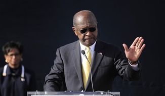 Then-Republican presidential candidate Herman Cain announces he is suspending his campaign as his wife, Gloria (left), looks on, on Saturday, Dec. 3, 2011, in Atlanta. (AP Photo/David Tulis) ** FILE **
