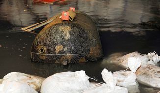 A defused World War II bomb sits the Rhine River near Koblenz, Germany. The massive British bomb that triggered the evacuation of about half of the 107,000 residents of Germany&#x27;s western city of Koblenz was defused Sunday, authorities said. (Associated Press)