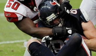 Falcons linebacker Curtis Lofton tries to pull Texans tight end Joel Dreessen back over the goal line as Dreesen scores a touchdown during the second quarter of Houston&#x27;s win over Atlanta. (Associated Press)