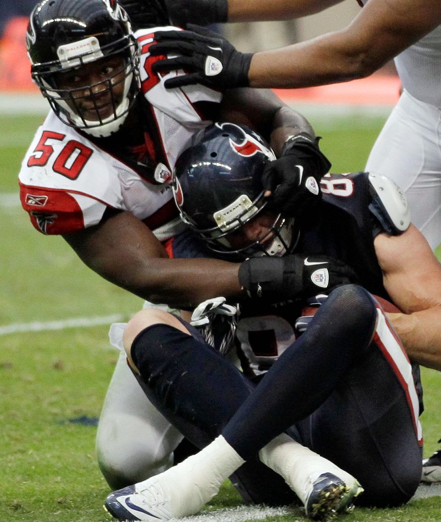 Falcons linebacker Curtis Lofton tries to pull Texans tight end Joel Dreessen back over the goal line as Dreesen scores a touchdown during the second quarter of Houston's win over Atlanta. (Associated Press)