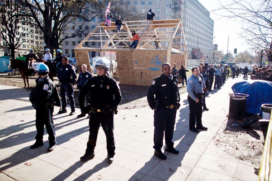 Park Police and MPD form a perimeter around a new structure the was erected in McPherson Square, in Washington, D.C. on Dec. 4, 2011.
(T.J. Kirkpatrick/ The Washington Times)