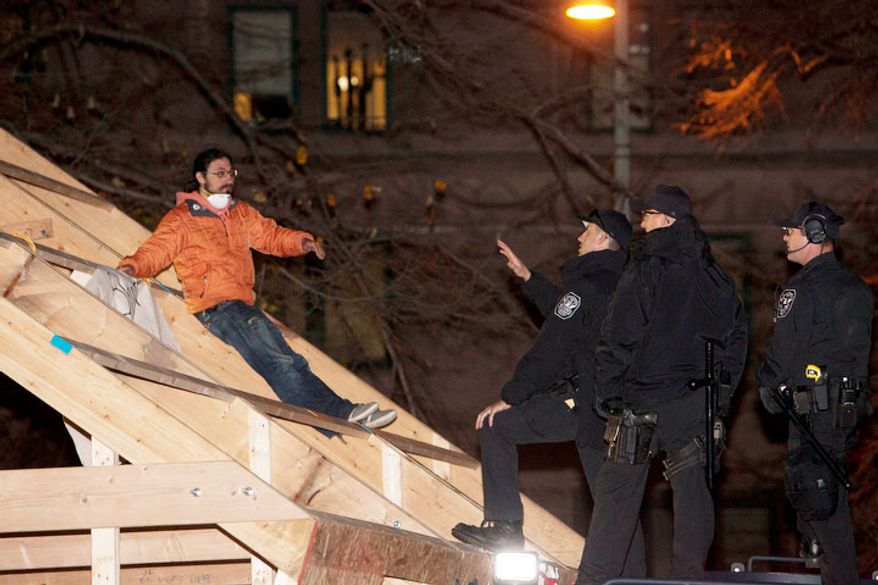 Park Police attempt to arrest protestors on the roof of a new structure the was erected in McPherson Square, in Washington, D.C. on Dec. 4, 2011.
(T.J. Kirkpatrick/ The Washington Times)