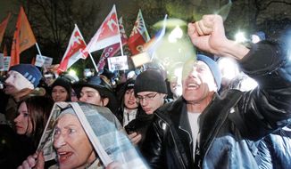 Supporters of Russian opposition parties chant anti-goverment slogans during a rally in Moscow on Monday. It was thought to be the largest opposition rally in years and ended with police detaining some of the activists. They chanted &quot;Russia without Putin.&quot; (Associated Press)