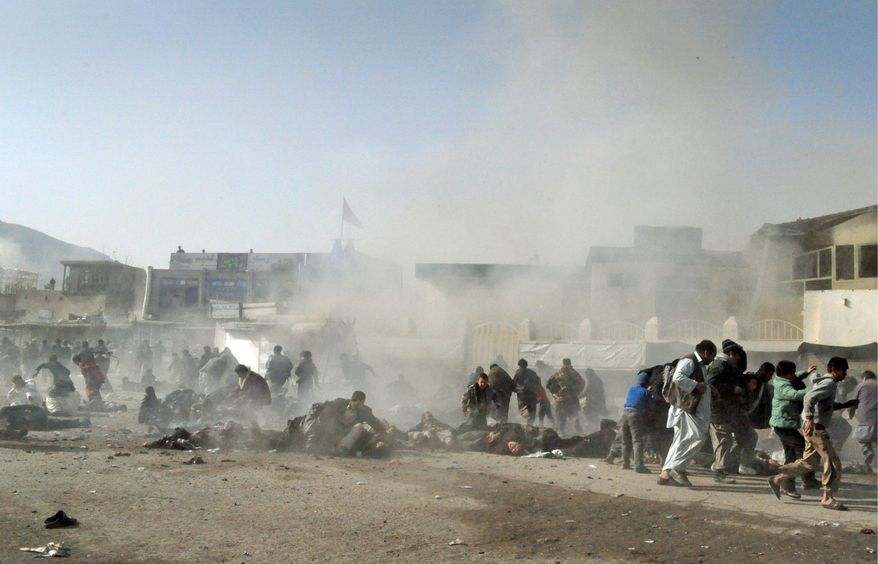 Smoke and dust rises at the scene of a suicide bomb attack Tuesday that killed 56 during a Muharram procession outside the Abul Fazl shrine in Kabul, Afghanistan. "It was a very powerful blast. ... Everyone was crying, shouting," said Mahood Khan, who is in charge of the shrine near the presidential palace. "It is a disaster." (Associated Press)