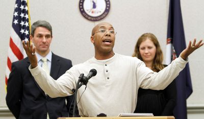 Thomas Haynesworth, who spent 27 years behind bars, center, gestures during a press conference with Virginia Attorney General Kenneth Cuccinelli II, left, and Shawn Armbrust, of the Mid Atlantic Innocence Project, right, in Richmond, Va., Tuesday, Dec. 6, 2011. Haynesworth was exonerated of two 1984 sexual assault convictions. (AP Photo/Steve Helber)