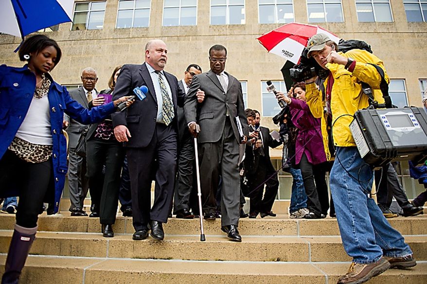 Former Prince George's County Executive Jack Johnson walks out of the U.S. District Courthouse in Greenbelt with his lawyer Jeff Harding, left, after being sentenced to seven years and three months after being found guilty for corruption in a pay-to-play scandal, Greenbelt, Md., Tuesday, Dec. 6, 2011. (Andrew Harnik/The Washington Times)