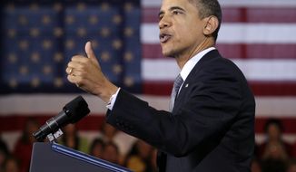 President Obama gestures while speaking about the economy on Tuesday, Dec. 6, 2011, at Osawatomie High School in Osawatomie, Kan. (AP Photo/Carolyn Kaster)