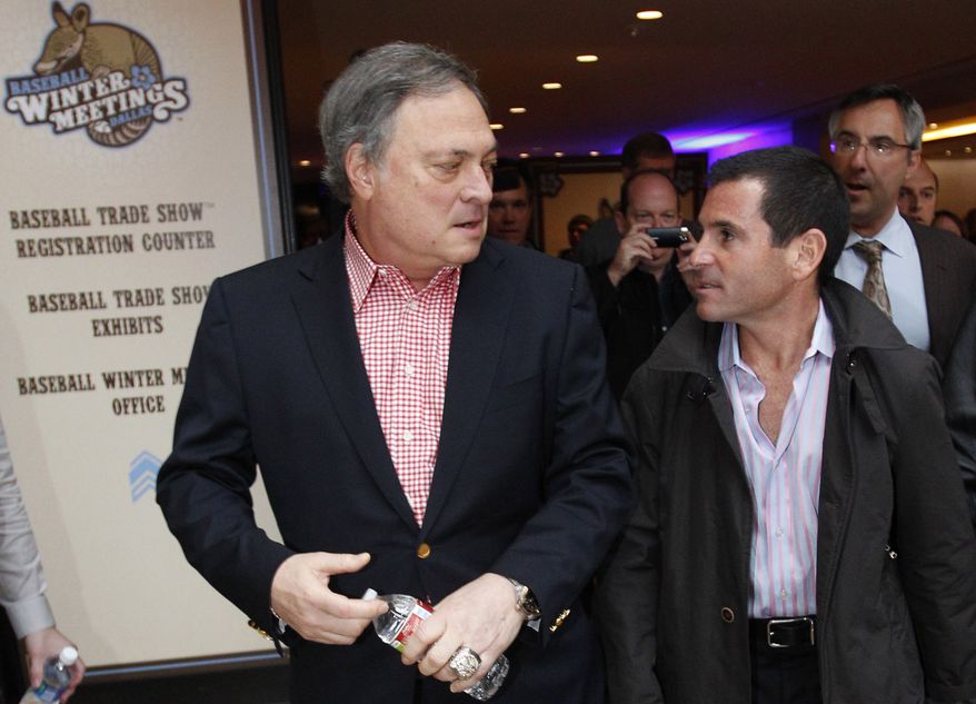 Florida Marlins owner Jeffrey Loria, left, and team president David Samson chat as they walk through the lobby of the hotel hosting Major League Baseball's winter meetings in Dallas, Tuesday, Dec. 6, 2011. (AP Photo/LM Otero) **FILE**