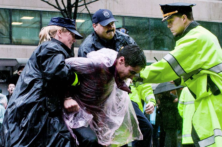 Occupy DC protesters are arrested as they block the intersection of 14th St. NW and K St. NW in Washington, D.C. on December 7, 2011. (T.J. Kirkpatrick/ The Washington Times)