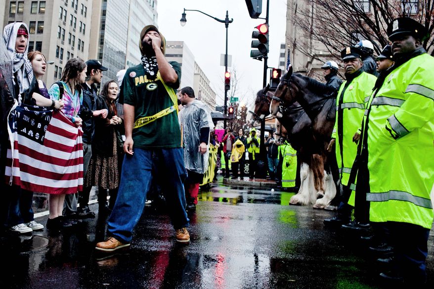 Occupy D.C. protesters stand off with police as they block 14th and K streets NW in Washington on Wednesday, Dec. 7, 2011. (T.J. Kirkpatrick/The Washington Times)