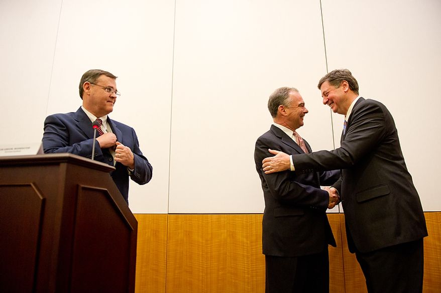 Former Virginia governors and current U.S. Senate candidates Tim Kaine (D), center, and George Allen (R), right, shake hands following their first debate for the 2012 campaign held at the annual AP Day at the Virginia State Capitol, Richmond, VA, Wednesday, December 7, 2011. Also pictured is Moderator Bob Gibson, Director of the Sorensen Institute for Political Leadership. (Andrew Harnik / The Washington Times)