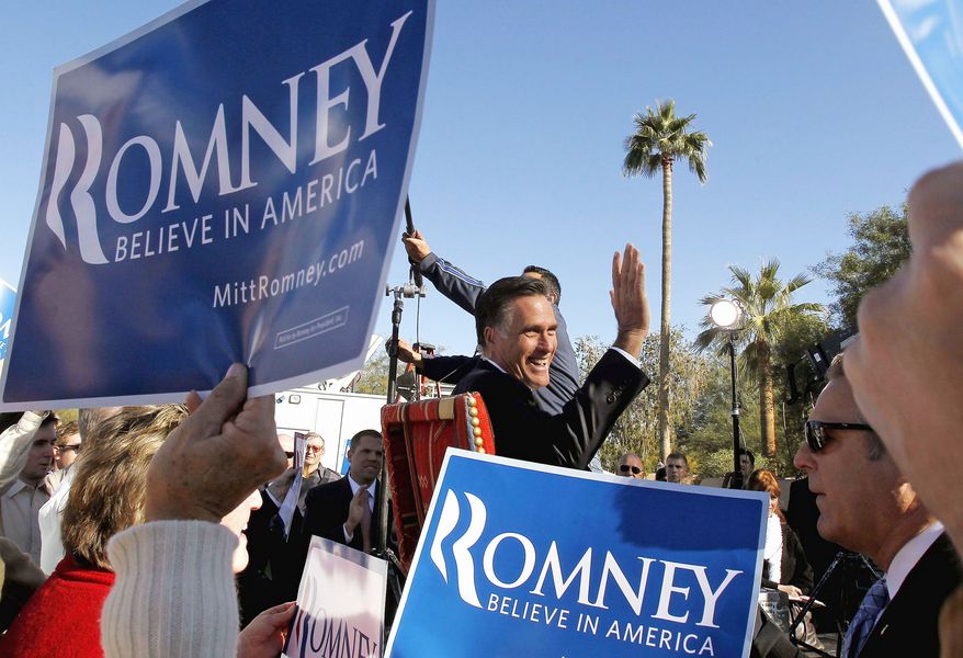 Former Massachusetts Gov. Mitt Romney, Newt Gingrich&#39;s presidential-primary rival , waves to supporters as he gives a television interview after a campaign event in Paradise Valley, Ariz., on Tuesday. (Associated Press)