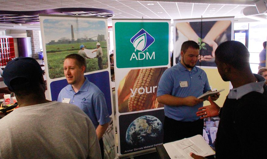 Archer Daniels Midland Co. employees answer questions and hand out job applications during a job fair on the Springfield campus of the University of Illinois on Thursday, Sept. 1, 2001, in Springfield, Ill. (AP Photo/Seth Perlman)