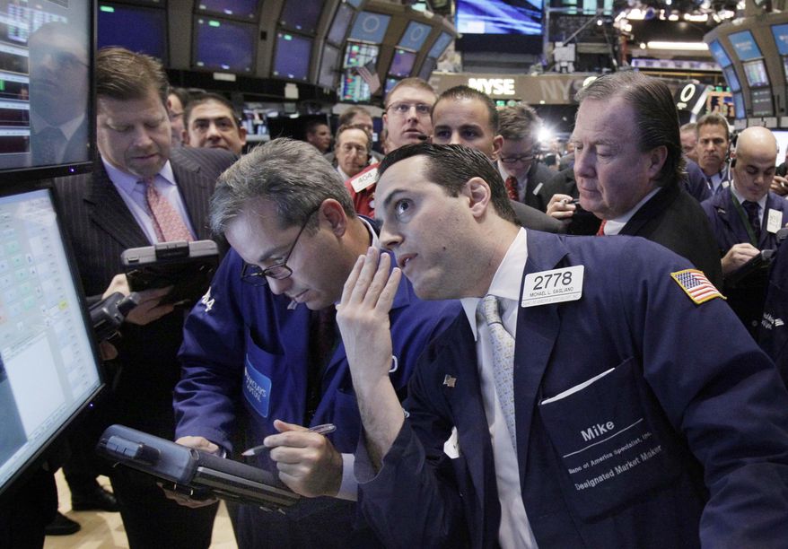 Specialist Michael Gagliano, foreground right, works at a post on the floor of the New York Stock Exchange during the IPO of Rose Rock Midstream, Friday, Dec. 9, 2011. U.S. stock indexes rose in early trading Friday after 26 European nations agreed to consider tying their economies together more closely in hopes of preventing another debt crisis. (AP Photo/Richard Drew)