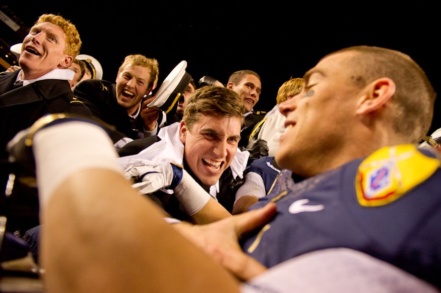 Navy Midshipmen celebrate with Navy Midshipmen running back Mike Stukel (17) in the stands after defeating the Army Black Nights 27-21 at Fedex Field, Landover, MD, Saturday, December 10, 2011. (Andrew Harnik / The Washington Times)