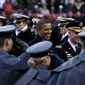 President Barack Obama, at center, crosses the field to sit on the Army side during half time in the tied 14-14 Army-Navy game at FedEx Field in Landover, Md., on Dec. 10, 2011. (T.J. Kirkpatrick/The Washington Times)