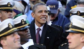 President Barack Obama looks on from the stands in the first half of the 112th edition of the annual Army vs. Navy NCAA college football game at FedEx Field in Landover, Md., Saturday, Dec. 10, 2011. (AP Photo/Nick Wass)