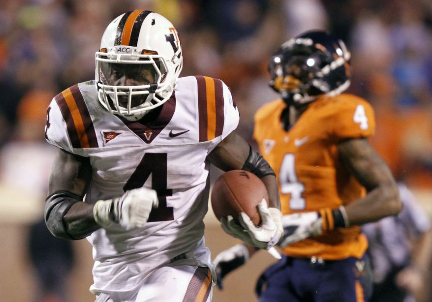 Virginia Tech running back David Wilson heads to the end zone as Virginia safety Rodney McLeod chases during the second half at Scott Stadium in Charlottesville, Va., Saturday, Nov. 26, 2011. Virginia Tech won the game 38-0. (AP Photo/Steve Helber)