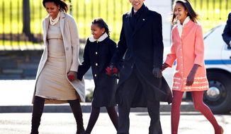 ** FILE ** In this December 2011 file photo, President Obama with first lady Michelle Obama and their daughters, Sasha and Malia, walk from the White House to attend a Sunday service at St. John&#39;s Church, where every president since James Madison has worshipped. (Associated Press)