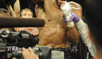 Lamont Peterson celebrates his win over Amir Khan in a boxing match, Sunday, Dec. 11, 2011, in Washington. (AP Photo/Nick Wass)