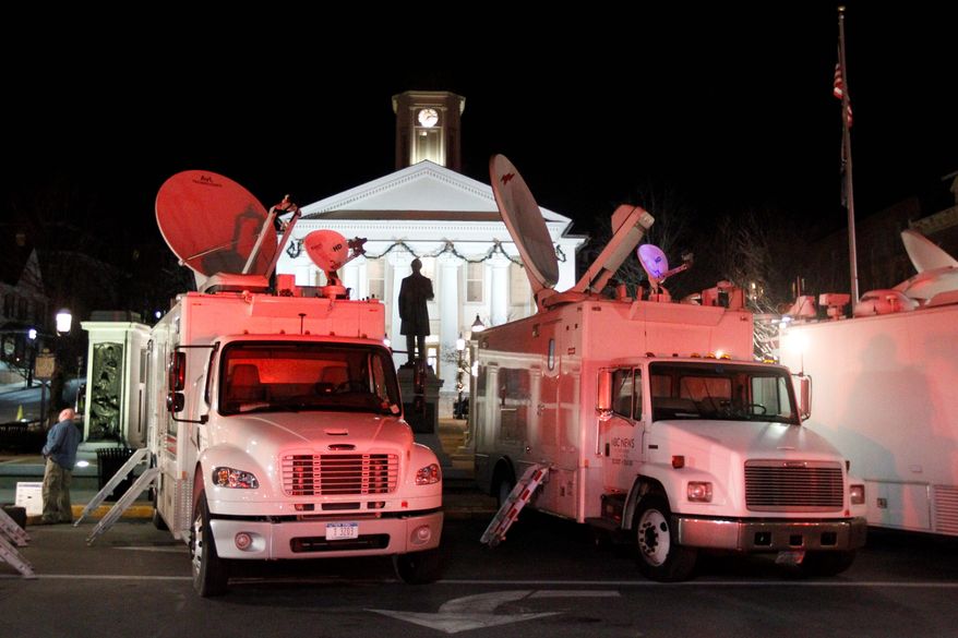 News trucks line the street in front of the Centre County Courthouse on Monday, Dec. 12, 2011, in Bellefonte, Pa. Former Penn State assistant football coach Jerry Sandusky, charged with more than 50 counts of child sex abuse, is scheduled to have a preliminary hearing at the courthouse on Tuesday. An order posted Monday says reporters will be allowed to email, send text messages and tweet from their laptop computers and handheld devices from inside the courtroom in Centre County during the hearing. (AP Photo/Matt Rourke)