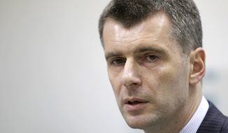 Mikhail Prokhorov, one of Russia&#39;s richest tycoons and the owner of the New Jersey Nets, announces his candidacy to run against Prime Minister Vladimir Putin for Russia&#39;s presidency on Monday, Dec. 12, 2011, in Moscow. (AP Photo/Misha Japaridze)