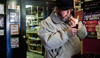 Peter Finkelstein of Annapolis lights a cigar at the Annapolis Cigar Co. A campaign is under way for the General Assembly to raise taxes on cigars and chewing tobacco to deter teens who use them as alternatives to more expensive cigarettes. (T.J. Kirkpatrick / The Washington Times)