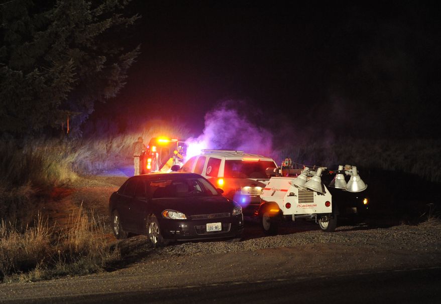 Crews enter the training area southwest of Joint Base Lewis-McChord, Wash., near the scene where two Army OH-58 Kiowa helicopters crashed, killing four soldiers on Monday, Dec. 12, 2011. (AP Photo/The News Tribune, Jeremy Harrison)