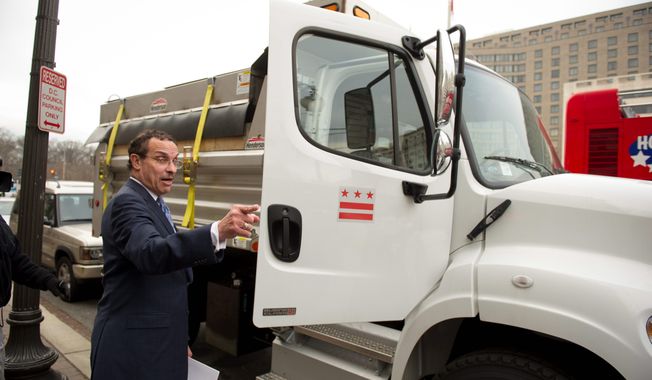 Mr. Gray gets into a 2012 Freightliner dump truck after discussing his new strategy for dealing with winter weather. (Rod Lamkey Jr./The Washington Times)